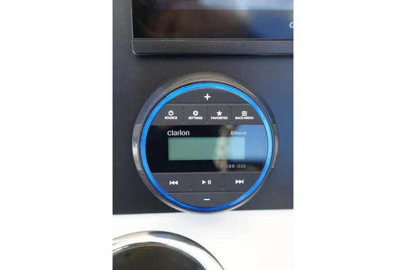 Slide: The Image of Clarion audio system in 2026 Robalo R202 Explorer boat dashboard. - 9