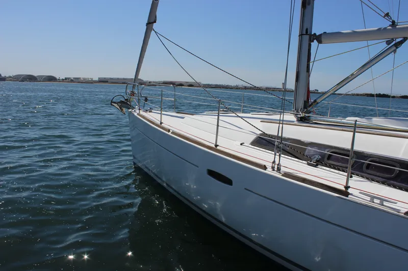 Slide: The Image of 2012 Beneteau Oceanis 37 sailboat on calm water, showcasing sleek design and craftsmanship. - 12