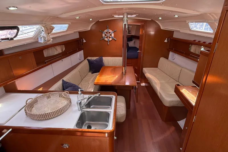 Slide: The Image of Interior of 2012 Beneteau Oceanis 37 yacht with cozy seating and wooden finishes. - 13