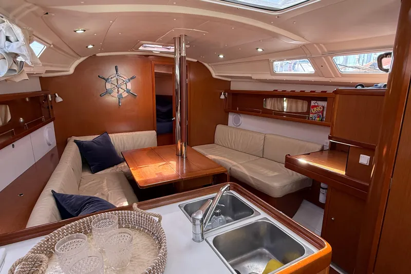 Slide: The Image of Interior of 2012 Beneteau Oceanis 37 yacht with cozy seating and wooden finishes. - 14