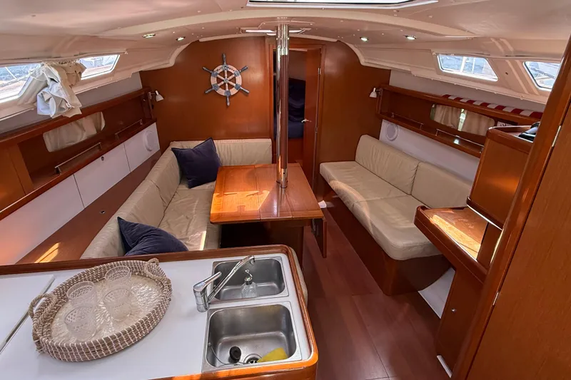 Slide: The Image of Interior of 2012 Beneteau Oceanis 37 yacht with cozy seating and wooden finishes. - 15