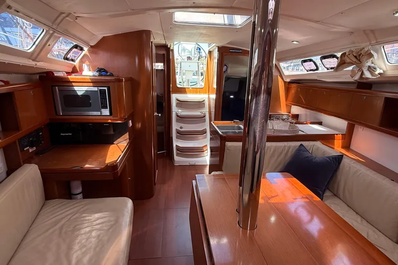 Slide: The Image of Interior of 2012 Beneteau Oceanis 37 sailboat with wood finish and modern amenities. - 16
