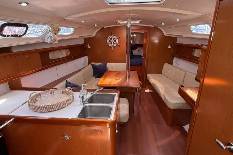 Slide: The Image of Interior of 2012 Beneteau Oceanis 37 yacht with cozy seating and wooden finishes. - 18