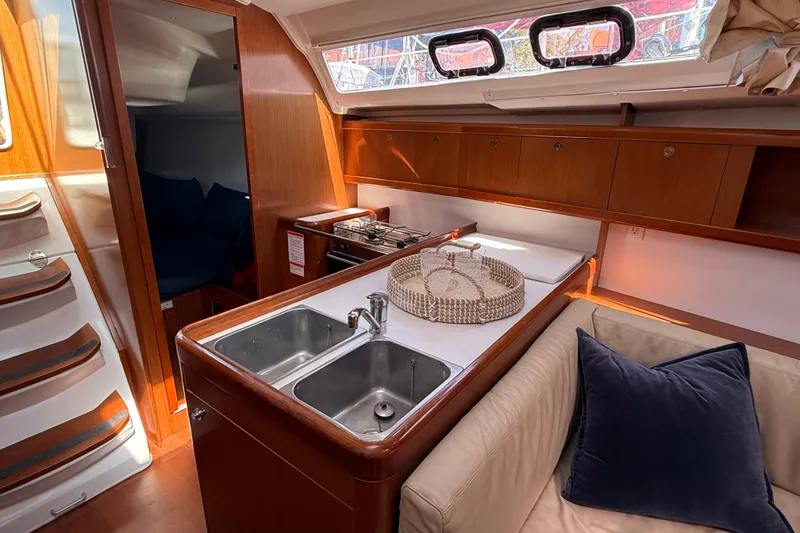 Slide: The Image of Interior of 2012 Beneteau Oceanis 37 yacht with kitchen and seating area. - 19