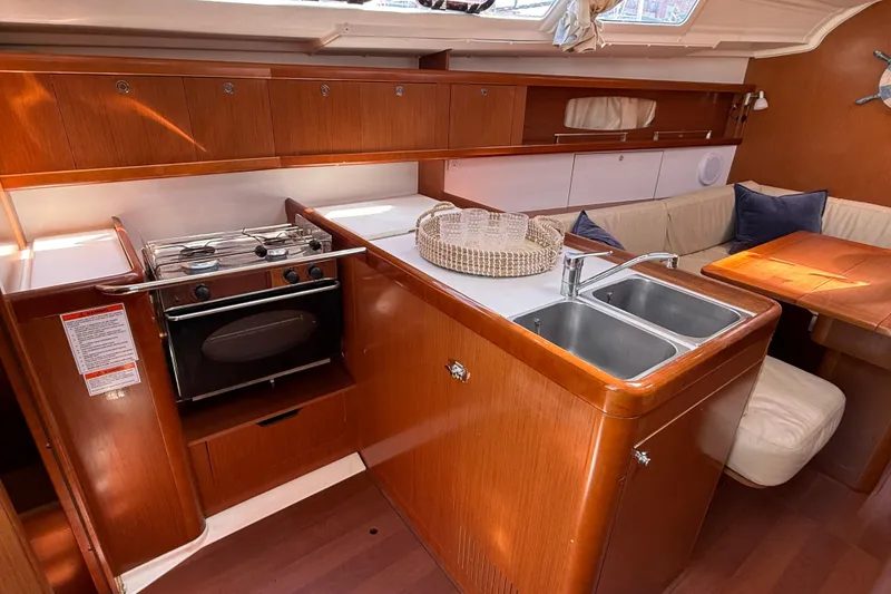 Slide: The Image of Interior of 2012 Beneteau Oceanis 37 yacht with kitchen and seating area. - 20
