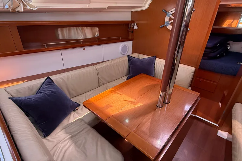 Slide: The Image of Interior of 2012 Beneteau Oceanis 37 yacht with cozy seating and wooden table. - 21