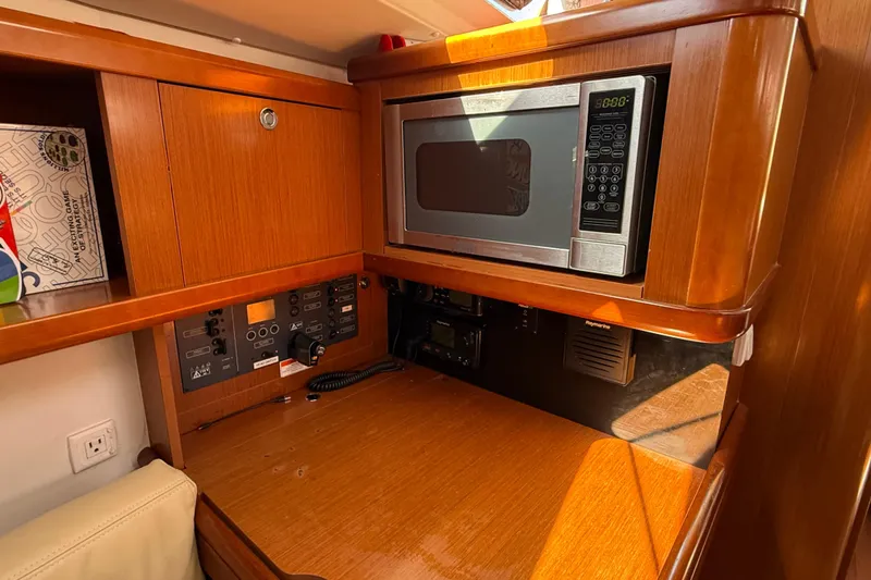 Slide: The Image of Interior of 2012 Beneteau Oceanis 37 yacht with microwave and control panel. - 22