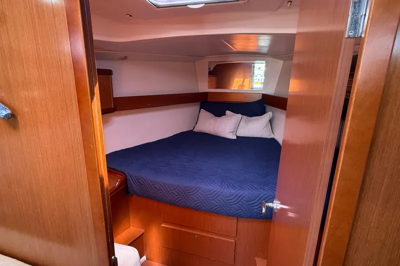 Slide: The Image of Cozy cabin interior of 2012 Beneteau Oceanis 37 sailboat with blue bedding. - 23