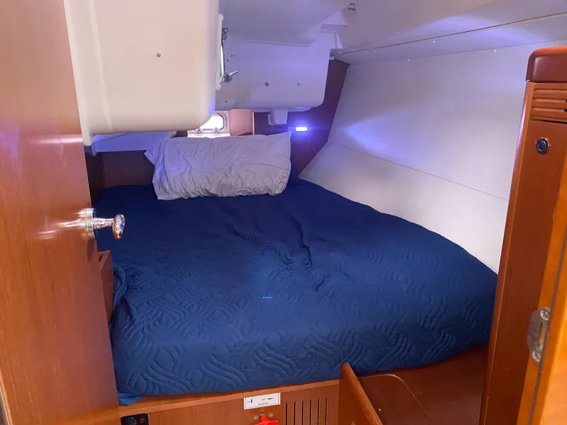 Slide: The Image of Beneteau Oceanis 37 cabin, 2012 model, featuring a cozy bed. - 24