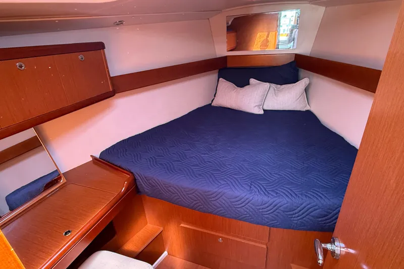 Slide: The Image of Cozy cabin interior of 2012 Beneteau Oceanis 37 sailboat with blue bedding. - 26