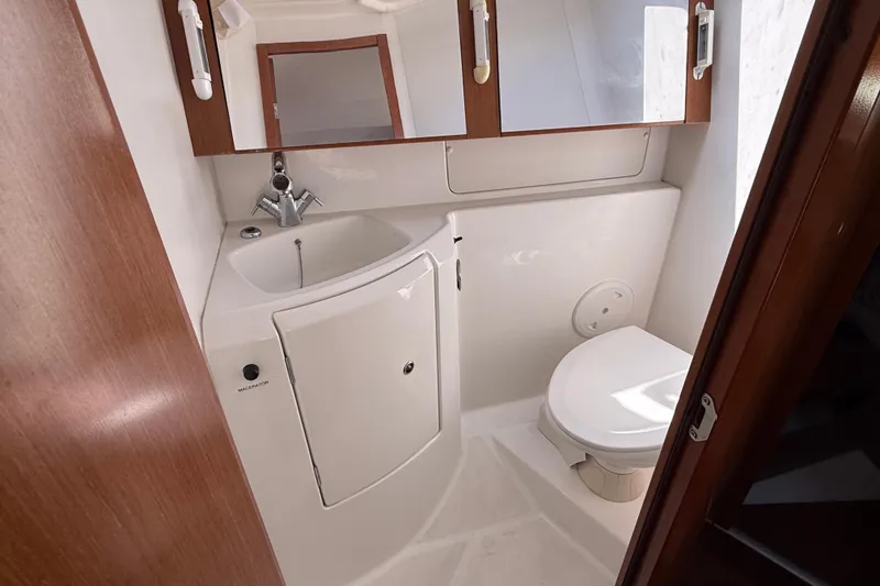 Slide: The Image of Compact bathroom in a 2012 Beneteau Oceanis 37 yacht, featuring sink and toilet. - 27