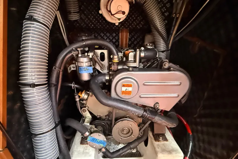 Slide: The Image of Engine compartment of a 2012 Beneteau Oceanis 37 sailboat, showcasing mechanical components. - 28