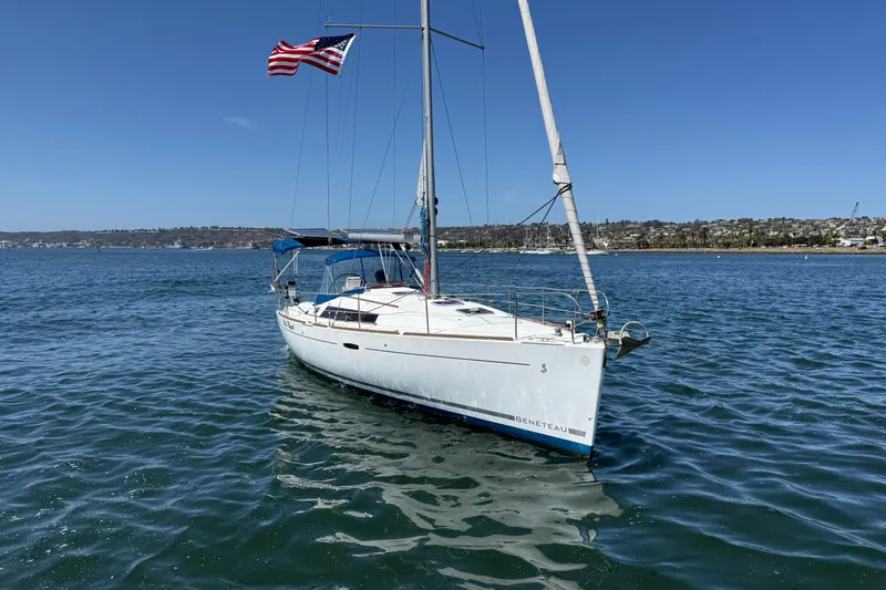 Slide: The Image of 2012 Beneteau Oceanis 37 sailboat on calm water, American flag waving. - 3