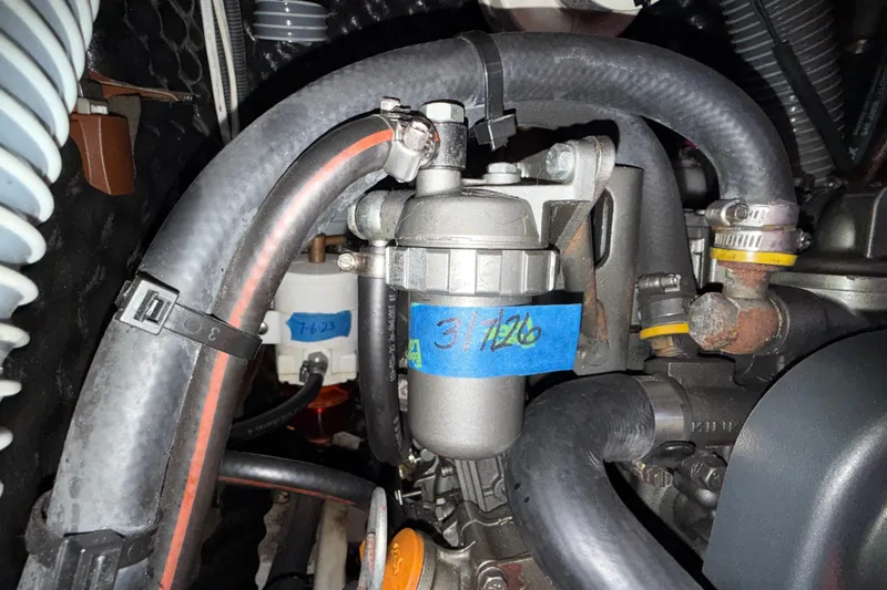 Slide: The Image of Engine compartment of a 2012 Beneteau Oceanis 37 sailboat, showing hoses and components. - 30
