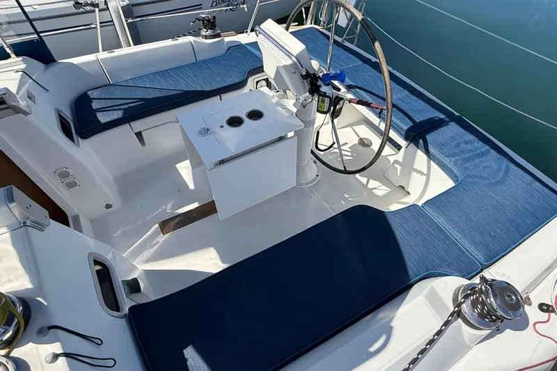Slide: The Image of Cockpit of 2012 Beneteau Oceanis 37 sailboat with blue cushions and steering wheel. - 31