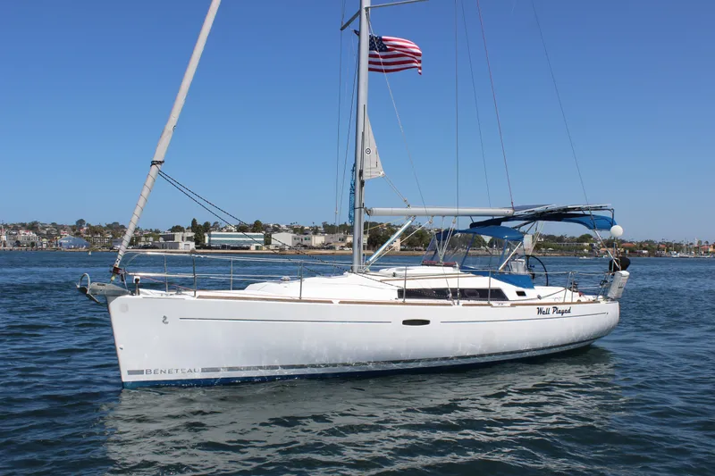 Slide: The Image of 2012 Beneteau Oceanis 37 sailboat on water, American flag, clear sky background. - 4