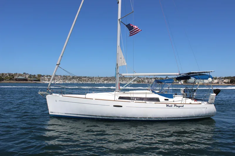 Slide: The Image of 2012 Beneteau Oceanis 37 sailboat on water, clear sky, American flag flying. - 5