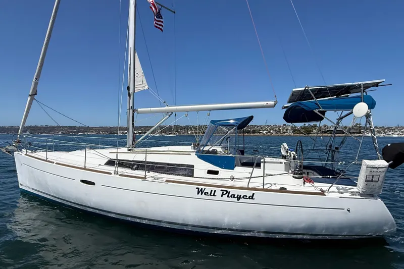 Slide: The Image of 2012 Beneteau Oceanis 37 sailboat named "Well Played" on the water, sunny day. - 6