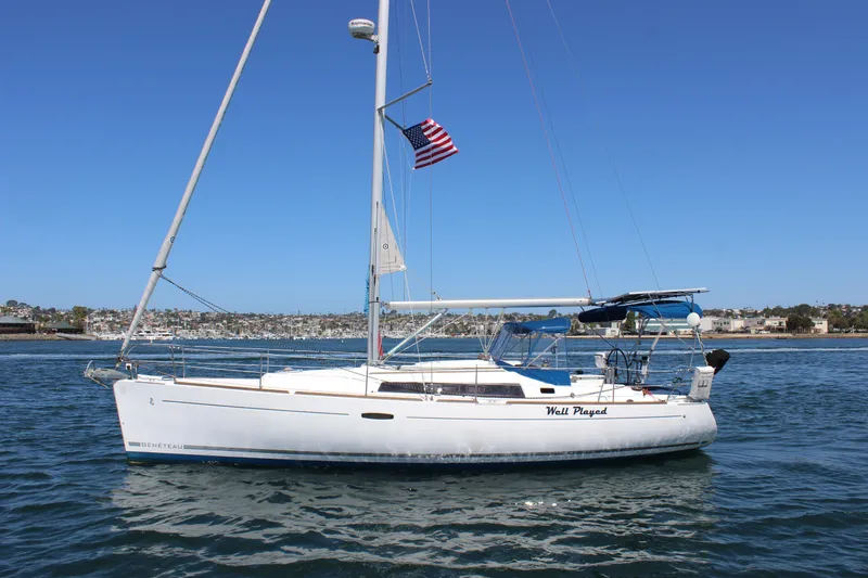 Slide: The Image of 2012 Beneteau Oceanis 37 sailboat on water, clear sky, American flag flying. - 7