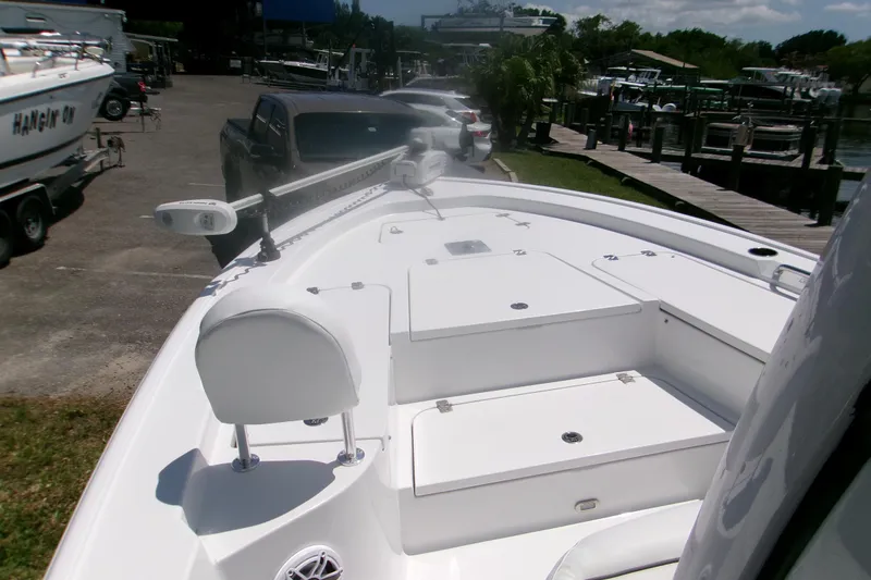 Slide: The Image of 2023 Sportsman Masters 247 Bay Boat docked, showcasing spacious deck and seating area. - 10