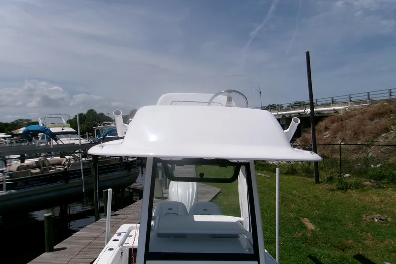 Slide: The Image of 2023 Sportsman Masters 247 Bay Boat docked under clear skies. - 12