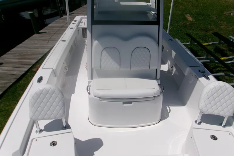 Slide: The Image of 2023 Sportsman Masters 247 Bay Boat interior with white seating and sleek design. - 13