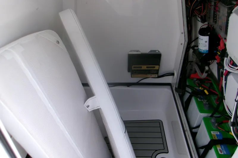 Slide: The Image of 2023 Sportsman Masters 247 Bay Boat interior with seating and electrical components. - 14