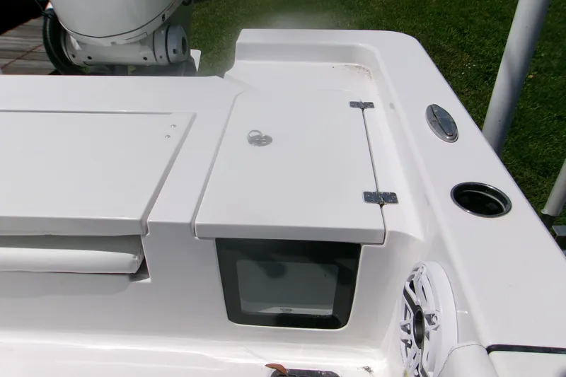 Slide: The Image of 2023 Sportsman Masters 247 Bay Boat deck with storage compartments and speaker. - 16