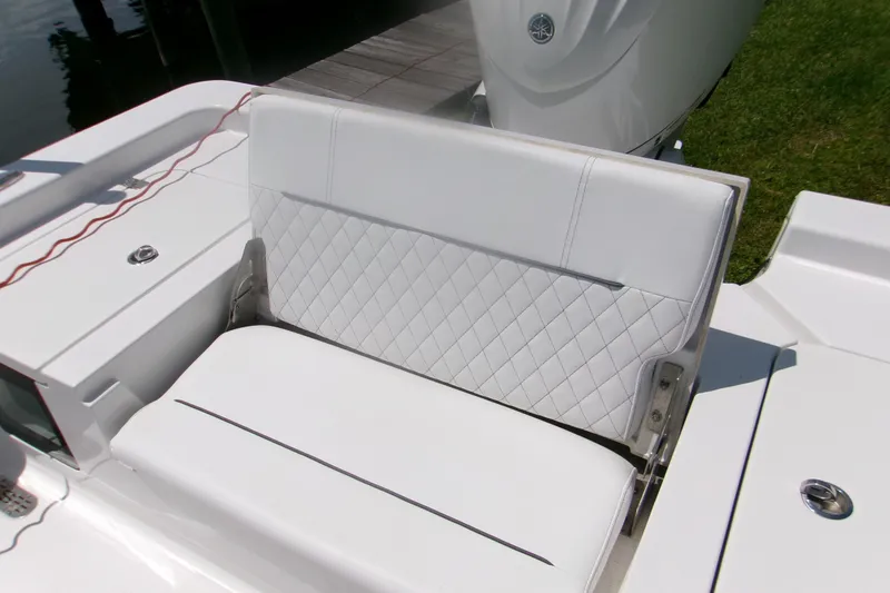 Slide: The Image of 2023 Sportsman Masters 247 Bay Boat with white cushioned seating and sleek design. - 17