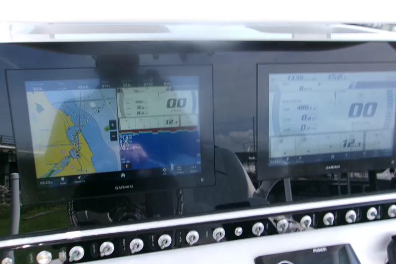 Slide: The Image of Dashboard of 2023 Sportsman Masters 247 Bay Boat with Garmin navigation displays. - 20