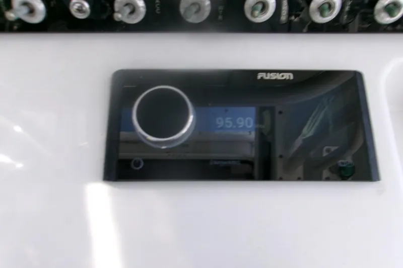 Slide: The Image of Close-up of Fusion audio system on 2023 Sportsman Masters 247 Bay Boat dashboard. - 21