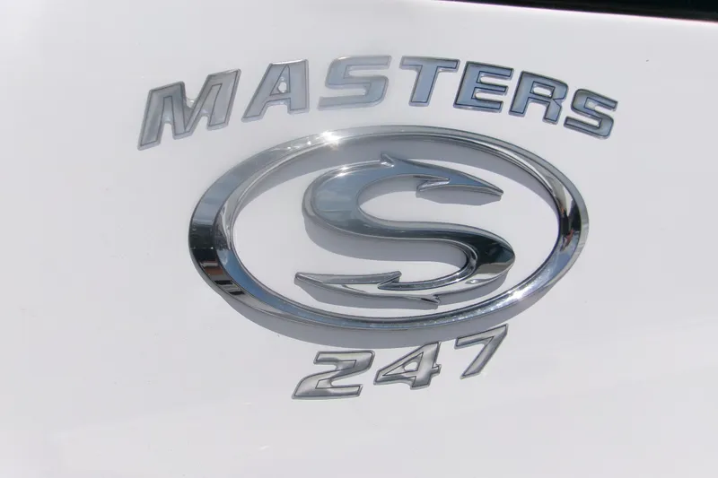 Slide: The Image of 2023 Sportsman Masters 247 Bay Boat logo on white surface. - 22