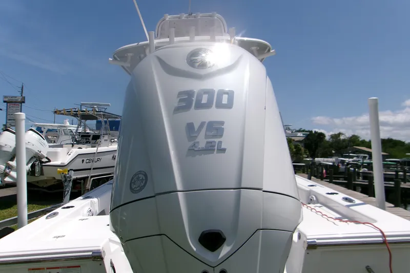 Slide: The Image of 2023 Sportsman Masters 247 Bay Boat with powerful 300 V6 engine, docked outdoors. - 4