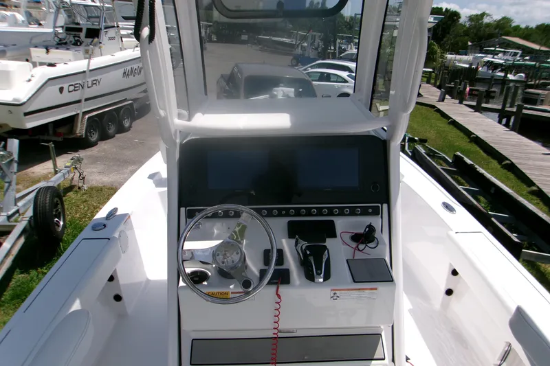 Slide: The Image of 2023 Sportsman Masters 247 Bay Boat dashboard with steering wheel and controls. - 6