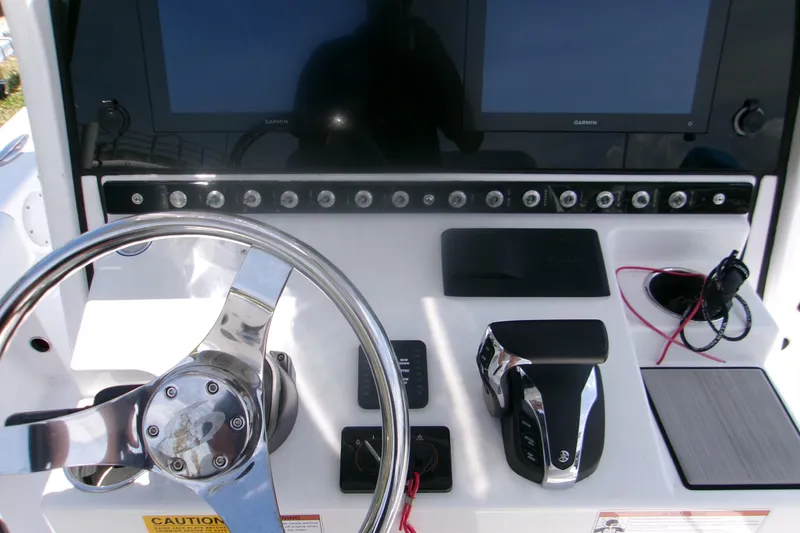 Slide: The Image of 2023 Sportsman Masters 247 Bay Boat dashboard with steering wheel and controls. - 9