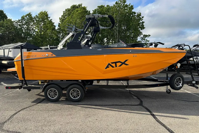 The Image of 2026 ATX Surf Boats 22 Type-S in vibrant orange on a trailer, parked outdoors. - 1
