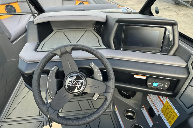 Slide: The Image of 2026 ATX Surf Boats 22 Type-S dashboard with steering wheel and touchscreen display. - 16