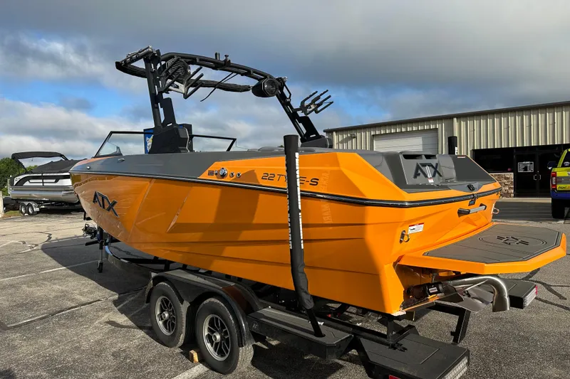 Slide: The Image of 2026 ATX Surf Boats 22 Type-S in vibrant orange, parked on a trailer. - 5