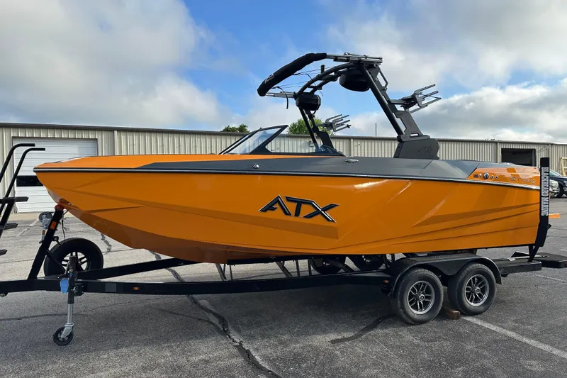 Slide: The Image of 2026 ATX Surf Boats 22 Type-S in vibrant orange on trailer, parked outdoors. - 6