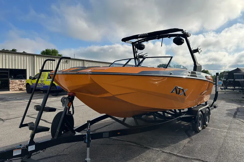Slide: The Image of 2026 ATX Surf Boats 22 Type-S in vibrant orange on trailer, parked outdoors. - 7