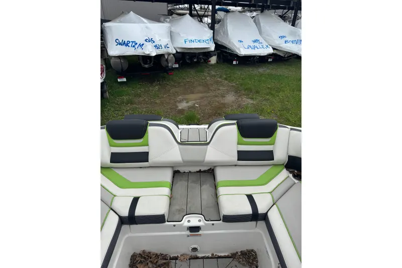 Slide: The Image of Interior view of a 2021 Yamaha Boats 212XD with green and black seating. - 12
