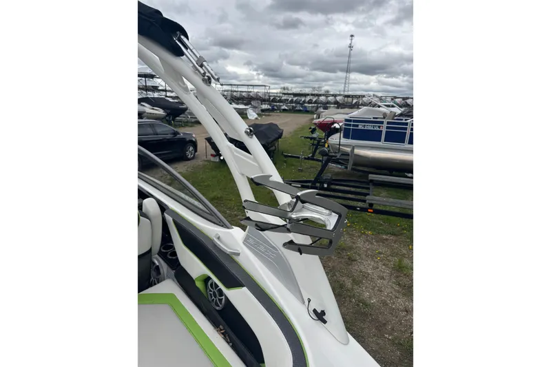 Slide: The Image of 2021 Yamaha Boats 212XD interior with sleek design and modern features, parked outdoors. - 13