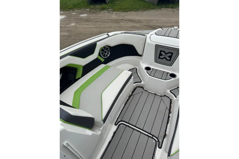 Slide: The Image of 2021 Yamaha Boats 212XD interior with green accents and sleek seating design. - 7