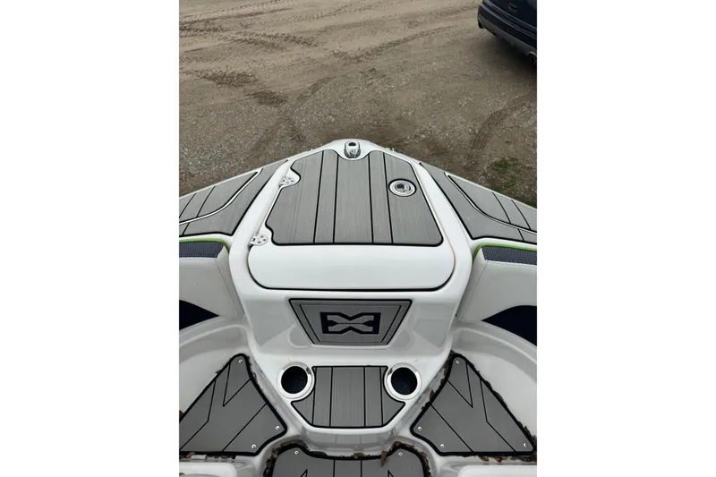 Slide: The Image of 2021 Yamaha Boats 212XD bow with sleek gray decking and storage compartment. - 8