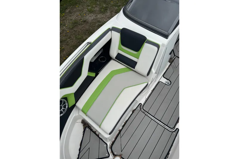 Slide: The Image of 2021 Yamaha Boats 212XD interior with green and white seating, gray flooring. - 9
