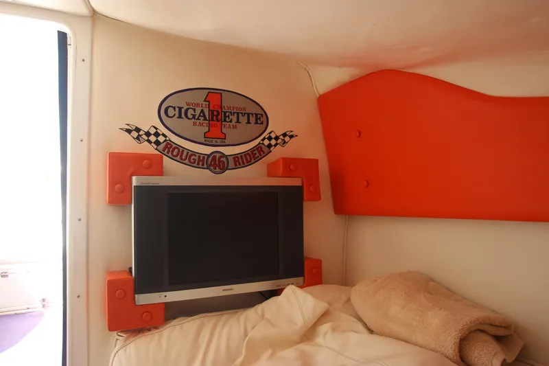 Slide: The Image of Interior of 2001 Cigarette 46 Rough Rider boat with TV and logo on wall. - 16
