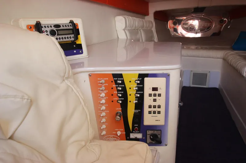Slide: The Image of Interior of 2001 Cigarette 46 Rough Rider boat with control panels and white seating. - 17
