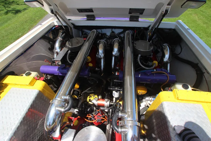 Slide: The Image of Engine compartment of a 2001 Cigarette 46 Rough Rider boat, featuring polished components. - 23