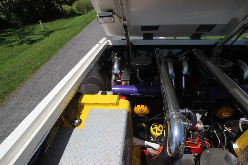 Slide: The Image of Engine compartment of a 2001 Cigarette 46 Rough Rider boat, featuring chrome exhaust pipes. - 26
