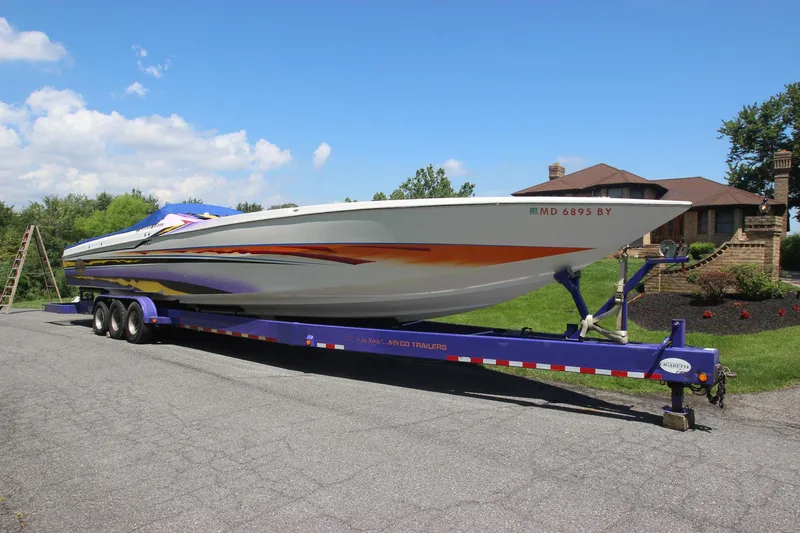 Slide: The Image of 2001 Cigarette 46 Rough Rider boat on a trailer, parked on a driveway. - 40